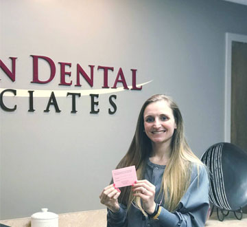 Danielle holding card in Dental Office